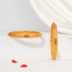 Traditional gold-toned silver bangles with intricate design and colored stone accents