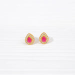 Teardrop gold stud earrings with pink center stones and clear crystal accents on white background