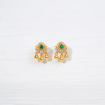 Gold-plated silver earrings with green stone and dangling gold beads on white background