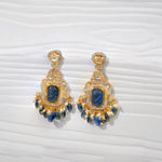 Gold-plated handmade earrings with blue stones, pearl accents, and intricate detailing