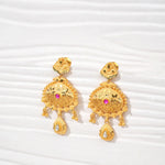 Traditional gold-plated filigree earrings with pink and white stone accents on white background
