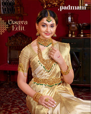 Woman in gold saree wearing traditional Indian 92.5 silver jewelry set with green accents