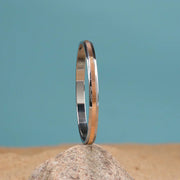 92.5 silver and gold plated bangle with textured design on stone against blue background