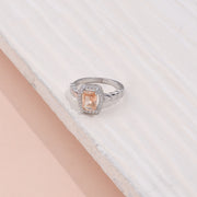 Elegant Silver Halo Ring with Peach Sapphire and CZ Accents